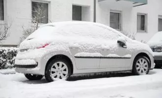 Cars parked in the streets are covered in ice